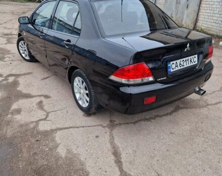 Чорний Міцубісі Lancer, об'ємом двигуна 1.6 л та пробігом 273 тис. км за 3999 $, фото 9 на Automoto.ua