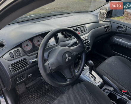 Чорний Міцубісі Lancer, об'ємом двигуна 1.58 л та пробігом 185 тис. км за 3750 $, фото 11 на Automoto.ua
