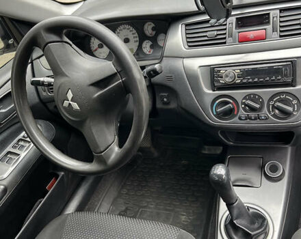 Чорний Міцубісі Lancer, об'ємом двигуна 1.58 л та пробігом 256 тис. км за 4200 $, фото 13 на Automoto.ua