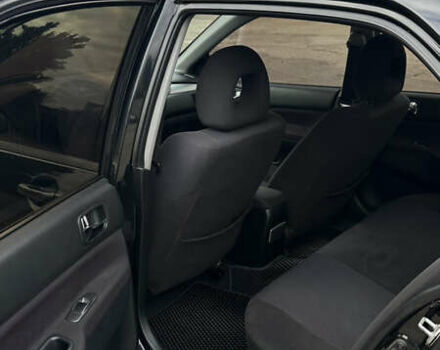 Черный Мицубиси Лансер, объемом двигателя 2 л и пробегом 143 тыс. км за 4999 $, фото 6 на Automoto.ua