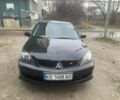 Черный Мицубиси Лансер, объемом двигателя 2 л и пробегом 240 тыс. км за 5600 $, фото 1 на Automoto.ua