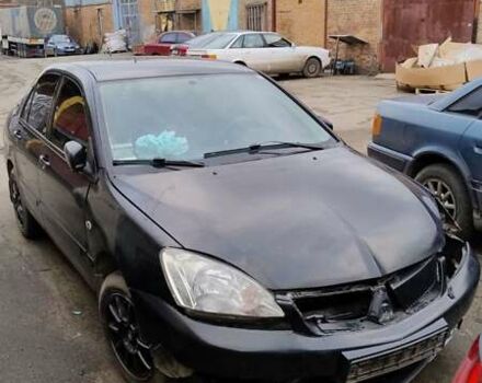 Черный Мицубиси Лансер, объемом двигателя 1.6 л и пробегом 200 тыс. км за 2000 $, фото 1 на Automoto.ua