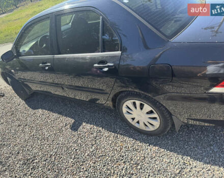 Черный Мицубиси Лансер, объемом двигателя 1.58 л и пробегом 205 тыс. км за 4500 $, фото 3 на Automoto.ua