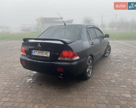 Черный Мицубиси Лансер, объемом двигателя 1.58 л и пробегом 211 тыс. км за 6333 $, фото 5 на Automoto.ua