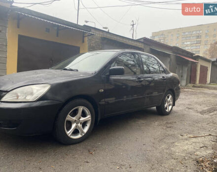 Черный Мицубиси Лансер, объемом двигателя 1.6 л и пробегом 143 тыс. км за 3000 $, фото 2 на Automoto.ua