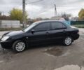 Черный Мицубиси Лансер, объемом двигателя 1.6 л и пробегом 270 тыс. км за 3800 $, фото 1 на Automoto.ua