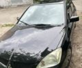 Черный Мицубиси Лансер, объемом двигателя 1.6 л и пробегом 300 тыс. км за 4000 $, фото 1 на Automoto.ua