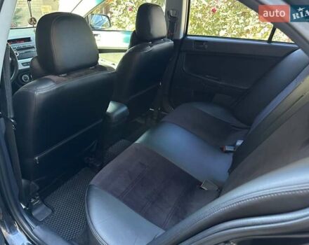 Черный Мицубиси Лансер, объемом двигателя 2 л и пробегом 230 тыс. км за 7000 $, фото 4 на Automoto.ua