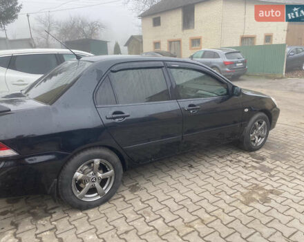 Черный Мицубиси Лансер, объемом двигателя 1.58 л и пробегом 211 тыс. км за 6333 $, фото 27 на Automoto.ua