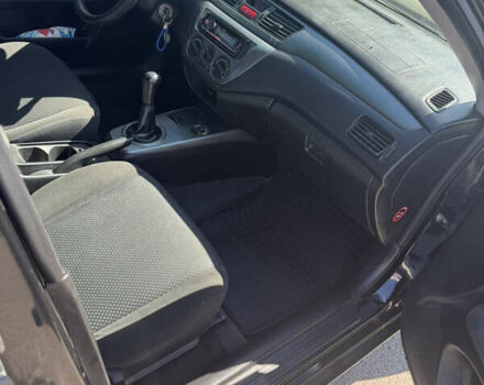 Черный Мицубиси Лансер, объемом двигателя 1.58 л и пробегом 205 тыс. км за 4500 $, фото 6 на Automoto.ua