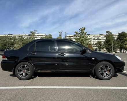 Черный Мицубиси Лансер, объемом двигателя 1.6 л и пробегом 321 тыс. км за 5000 $, фото 1 на Automoto.ua