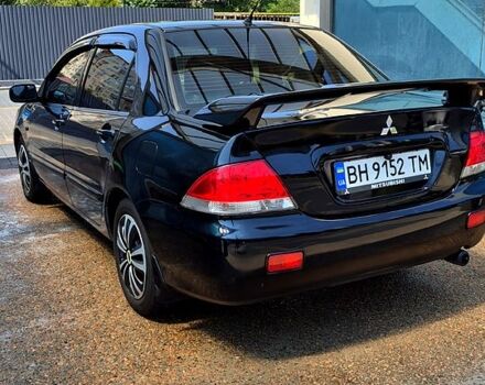 Черный Мицубиси Лансер, объемом двигателя 1.6 л и пробегом 205 тыс. км за 5500 $, фото 1 на Automoto.ua