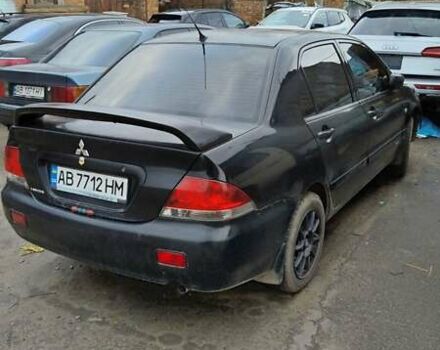 Черный Мицубиси Лансер, объемом двигателя 1.6 л и пробегом 200 тыс. км за 2000 $, фото 2 на Automoto.ua