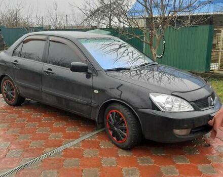 Черный Мицубиси Лансер, объемом двигателя 1.6 л и пробегом 256 тыс. км за 6300 $, фото 1 на Automoto.ua