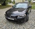 Черный Мицубиси Лансер, объемом двигателя 2 л и пробегом 214 тыс. км за 6100 $, фото 1 на Automoto.ua