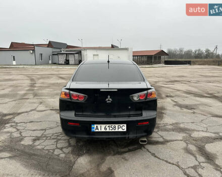 Черный Мицубиси Лансер, объемом двигателя 2 л и пробегом 142 тыс. км за 9500 $, фото 3 на Automoto.ua