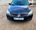 Чорний Міцубісі Lancer, об'ємом двигуна 1.6 л та пробігом 290 тис. км за 1999 $, фото 1 на Automoto.ua