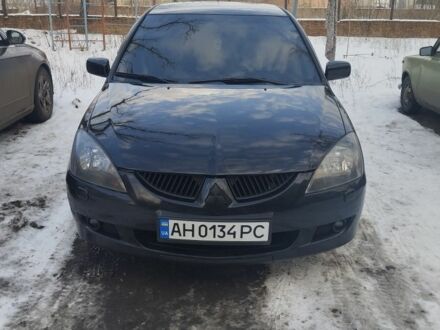 Черный Мицубиси Лансер, объемом двигателя 2 л и пробегом 231 тыс. км за 5199 $, фото 1 на Automoto.ua