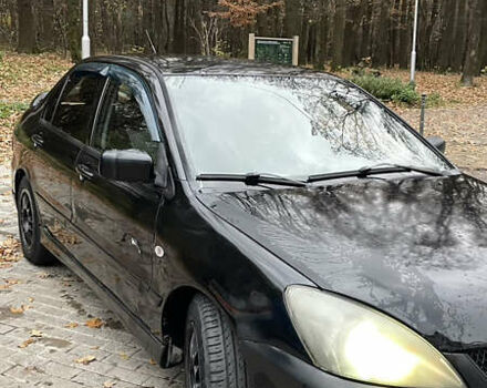 Черный Мицубиси Лансер, объемом двигателя 1.6 л и пробегом 200 тыс. км за 3000 $, фото 1 на Automoto.ua