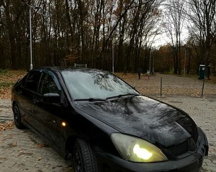 Черный Мицубиси Лансер, объемом двигателя 1.6 л и пробегом 200 тыс. км за 3000 $, фото 1 на Automoto.ua