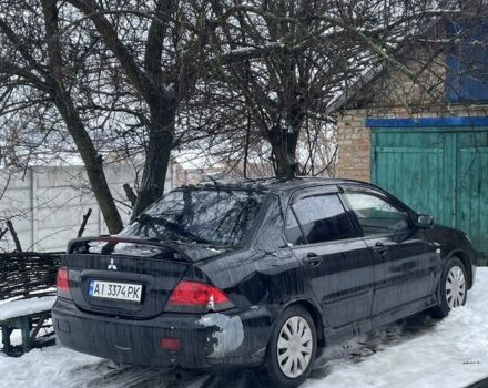 Черный Мицубиси Лансер, объемом двигателя 1.6 л и пробегом 350 тыс. км за 2400 $, фото 1 на Automoto.ua