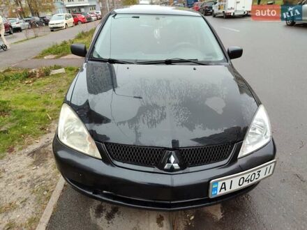 Черный Мицубиси Лансер, объемом двигателя 1.58 л и пробегом 270 тыс. км за 4000 $, фото 1 на Automoto.ua