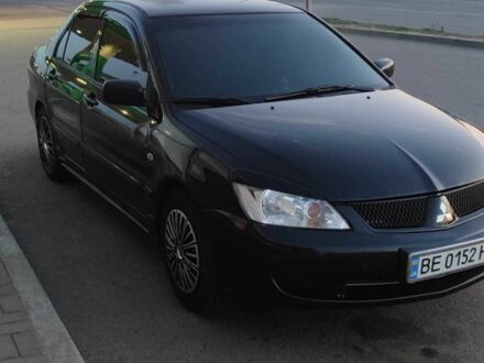 Черный Мицубиси Лансер, объемом двигателя 1.6 л и пробегом 245 тыс. км за 3600 $, фото 1 на Automoto.ua