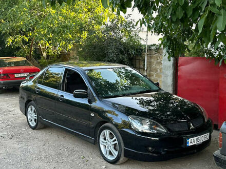 Черный Мицубиси Лансер, объемом двигателя 2 л и пробегом 255 тыс. км за 5000 $, фото 1 на Automoto.ua