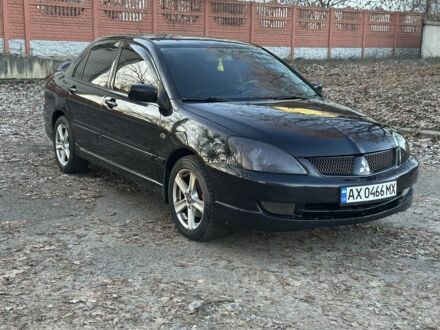 Черный Мицубиси Лансер, объемом двигателя 2 л и пробегом 300 тыс. км за 3999 $, фото 1 на Automoto.ua