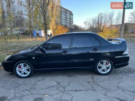 Черный Мицубиси Лансер, объемом двигателя 2 л и пробегом 280 тыс. км за 5400 $, фото 1 на Automoto.ua