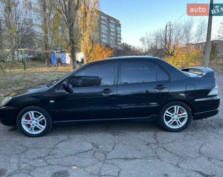 Черный Мицубиси Лансер, объемом двигателя 2 л и пробегом 280 тыс. км за 5400 $, фото 1 на Automoto.ua