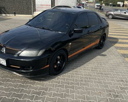 Черный Мицубиси Лансер, объемом двигателя 2 л и пробегом 224 тыс. км за 5700 $, фото 1 на Automoto.ua