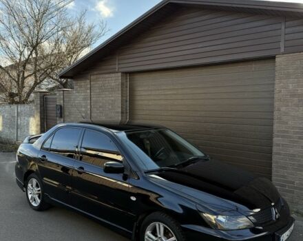 Черный Мицубиси Лансер, объемом двигателя 2 л и пробегом 220 тыс. км за 5250 $, фото 1 на Automoto.ua