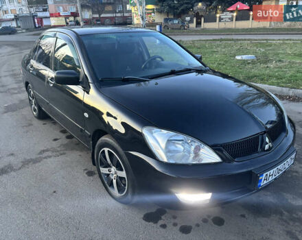 Черный Мицубиси Лансер, объемом двигателя 1.6 л и пробегом 315 тыс. км за 4000 $, фото 1 на Automoto.ua