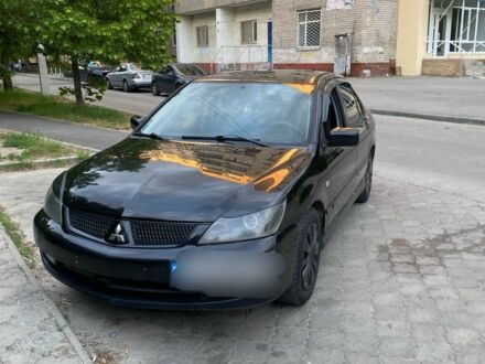 Черный Мицубиси Лансер, объемом двигателя 1.6 л и пробегом 235 тыс. км за 3500 $, фото 1 на Automoto.ua