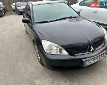 Черный Мицубиси Лансер, объемом двигателя 1.58 л и пробегом 290 тыс. км за 3000 $, фото 1 на Automoto.ua