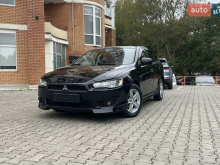 Черный Мицубиси Лансер, объемом двигателя 2 л и пробегом 200 тыс. км за 6199 $, фото 1 на Automoto.ua
