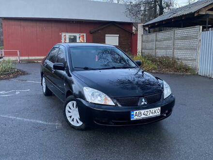 Черный Мицубиси Лансер, объемом двигателя 1.58 л и пробегом 280 тыс. км за 3650 $, фото 1 на Automoto.ua