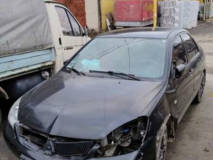 Черный Мицубиси Лансер, объемом двигателя 1.6 л и пробегом 200 тыс. км за 2000 $, фото 1 на Automoto.ua