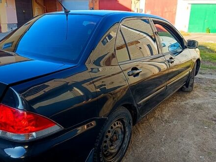 Черный Мицубиси Лансер, объемом двигателя 1.6 л и пробегом 230 тыс. км за 4700 $, фото 1 на Automoto.ua