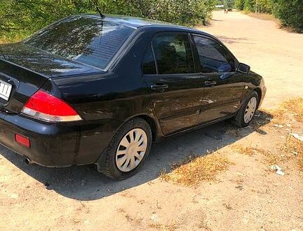 Черный Мицубиси Лансер, объемом двигателя 1.6 л и пробегом 245 тыс. км за 3200 $, фото 1 на Automoto.ua