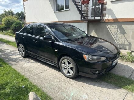 Черный Мицубиси Лансер, объемом двигателя 2 л и пробегом 210 тыс. км за 6250 $, фото 1 на Automoto.ua