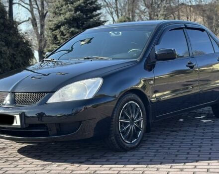 Черный Мицубиси Лансер, объемом двигателя 1.6 л и пробегом 200 тыс. км за 4500 $, фото 1 на Automoto.ua