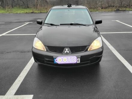 Черный Мицубиси Лансер, объемом двигателя 1.6 л и пробегом 170 тыс. км за 5000 $, фото 1 на Automoto.ua