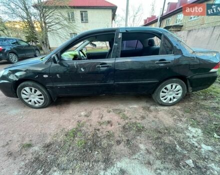 Черный Мицубиси Лансер, объемом двигателя 1.6 л и пробегом 105 тыс. км за 1700 $, фото 1 на Automoto.ua