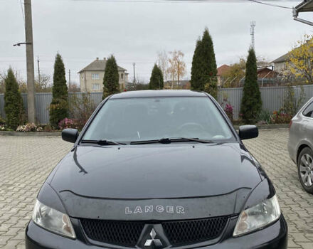 Чорний Міцубісі Lancer, об'ємом двигуна 1.58 л та пробігом 287 тис. км за 4750 $, фото 1 на Automoto.ua