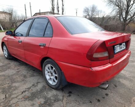 Красный Мицубиси Лансер, объемом двигателя 1.3 л и пробегом 409 тыс. км за 2000 $, фото 4 на Automoto.ua