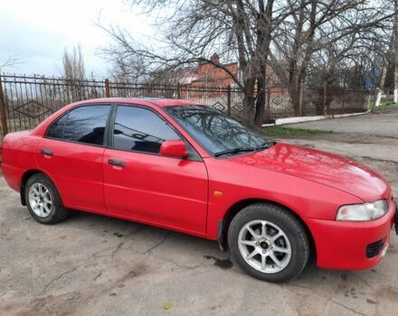 Красный Мицубиси Лансер, объемом двигателя 1.3 л и пробегом 409 тыс. км за 2000 $, фото 1 на Automoto.ua