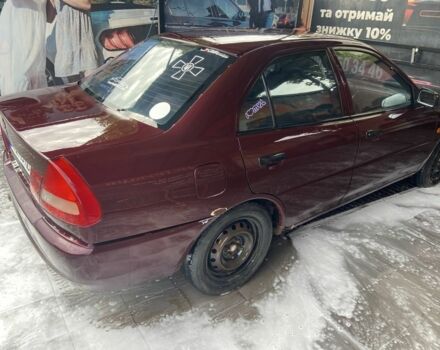 Красный Мицубиси Лансер, объемом двигателя 1.3 л и пробегом 275 тыс. км за 1500 $, фото 4 на Automoto.ua