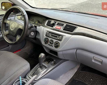 Красный Мицубиси Лансер, объемом двигателя 2 л и пробегом 202 тыс. км за 2599 $, фото 7 на Automoto.ua